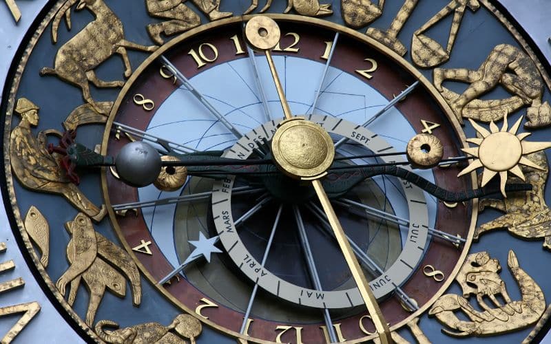 Magnifique horloge en métal avec les signes des zodiaques et un soleil, une lune. Dorée, bleue.